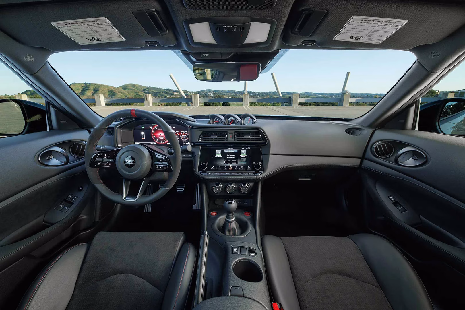 Nissan Z cockpit with manual gear lever, digital instruments and three dashboard gauges